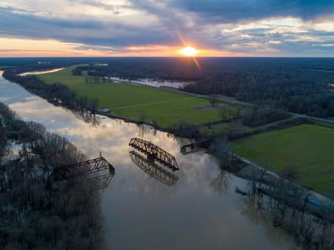 An aerial view of a river and bridge at sunset on Highway 465 near Redwood, MS